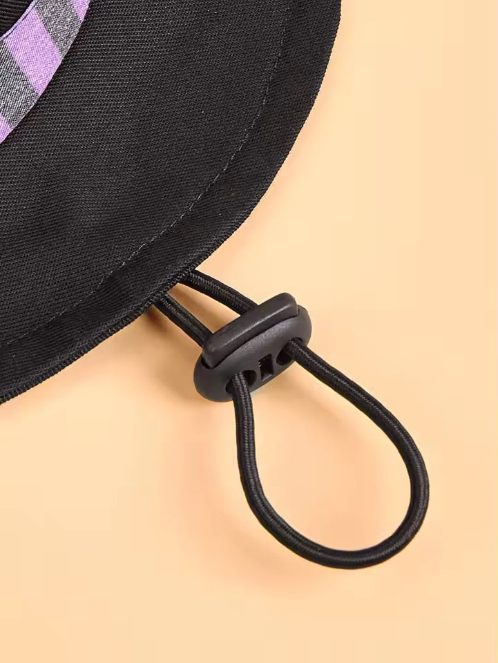 Close-up of a black bag with a drawstring on a beige background
