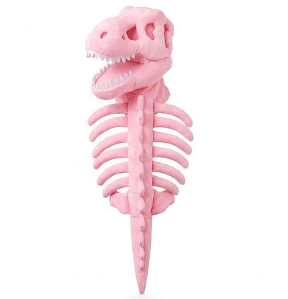 A pink plush dinosaur skeleton toy, shaped like a T-rex skull with an open mouth and a rib cage structure, photographed against a plain white background.