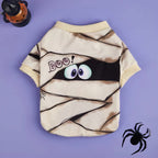 Halloween-themed dog shirt with mummy design and googly eyes on a purple background