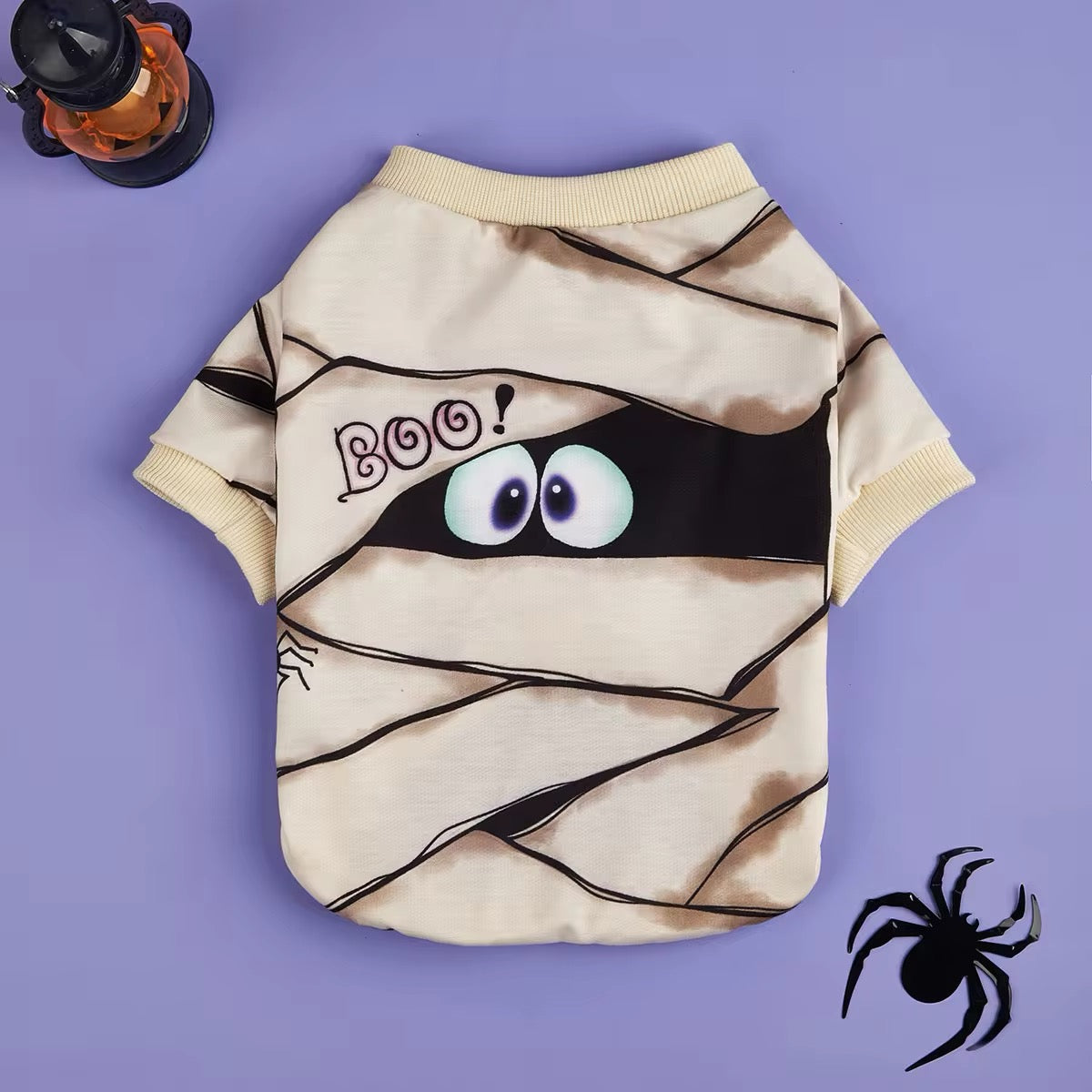 Halloween-themed dog shirt with mummy design and googly eyes on a purple background