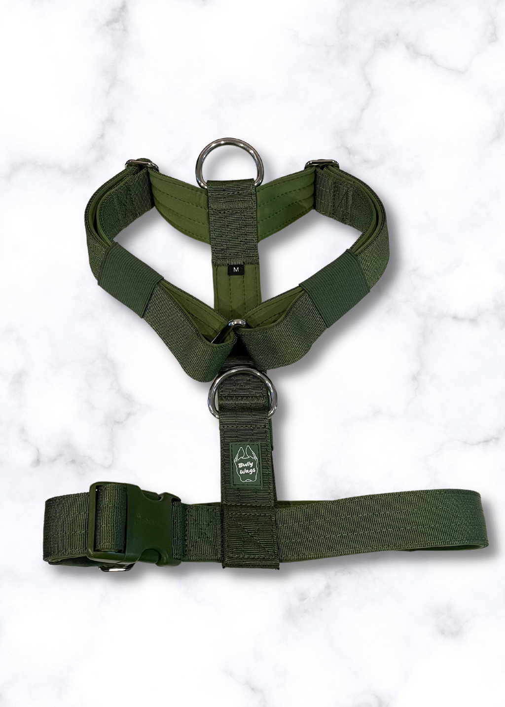 Green dog harness on a white marble background