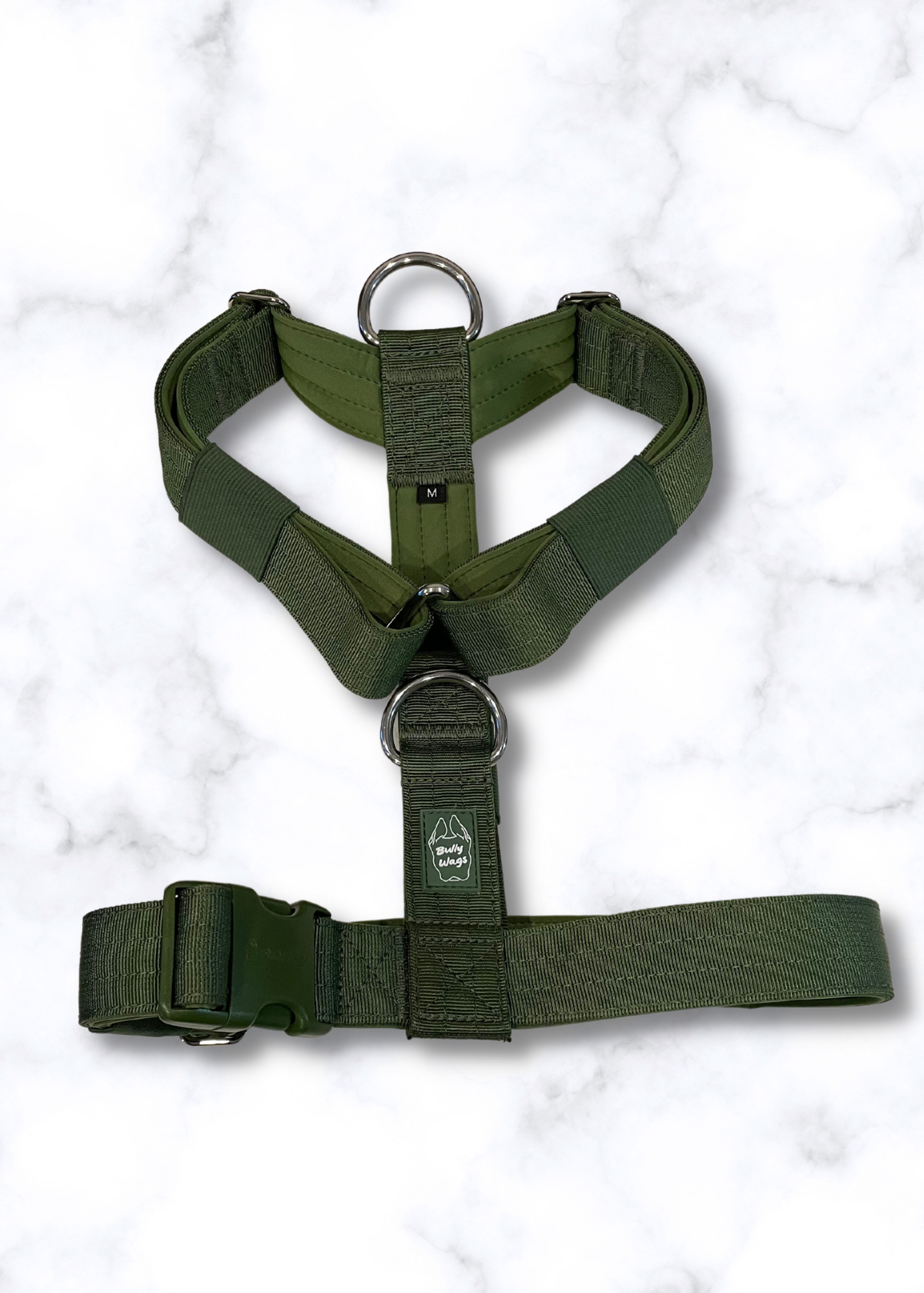 Green dog harness on a white marble background