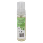 Clear spray bottle with green label on a white background