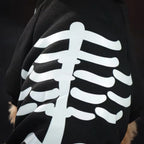 Black shirt with white skeleton design on a dark background