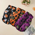 Three Halloween-themed dog coats in black, orange, and purple on a beige surface with flowers in the background.