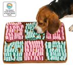 Dog interacting with a tray of pink and green dog treats, with a visible brand logo in the corner.