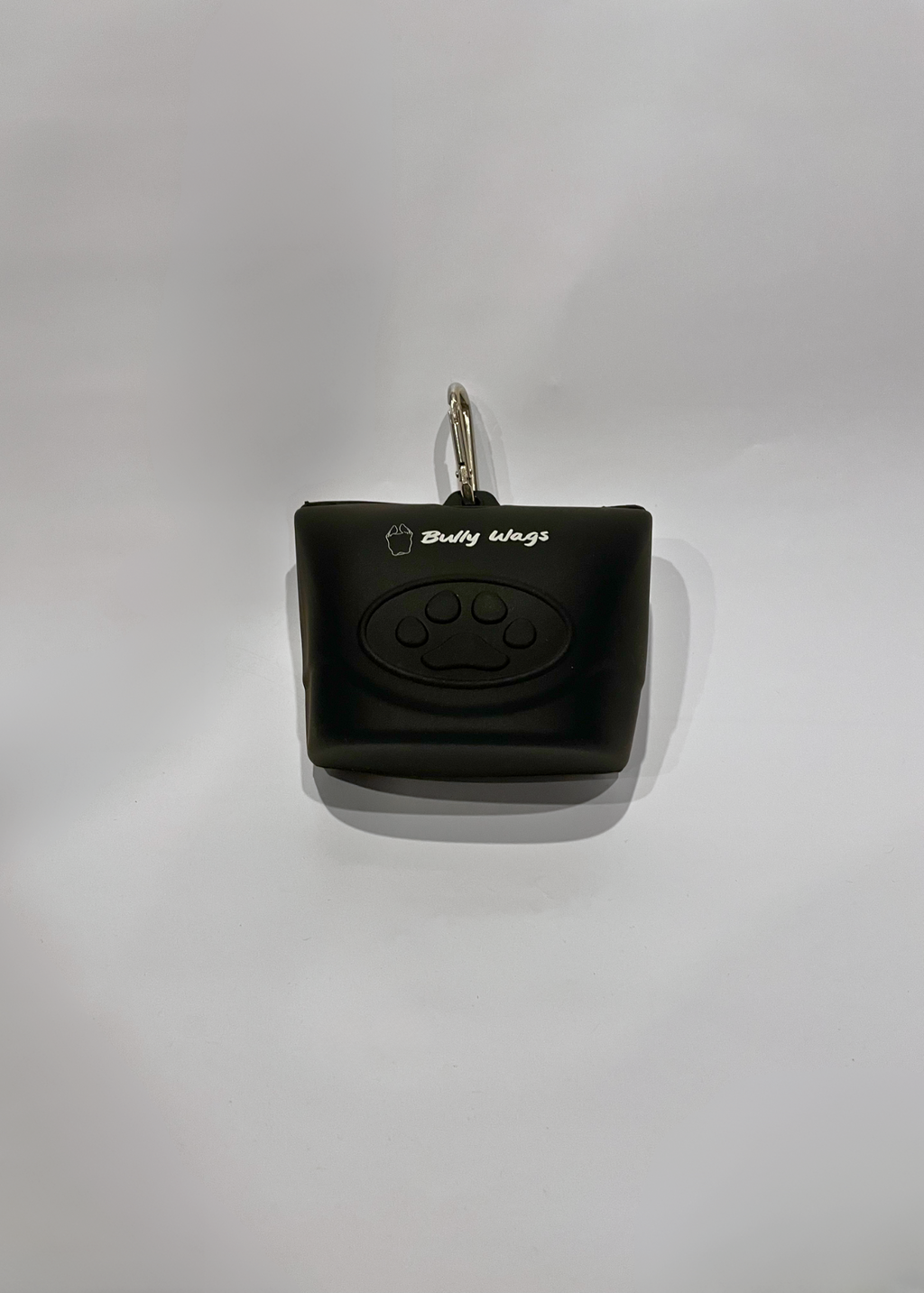 Black dog treat bag dispenser with a paw print design on a white background