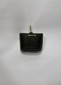Black dog treat bag dispenser with a paw print design on a white background
