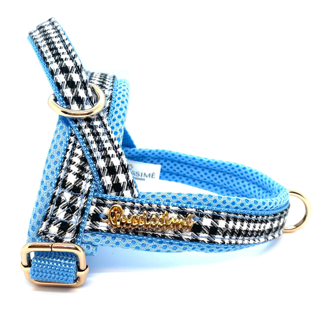 Dog harness with houndstooth pattern and blue accents on a white background