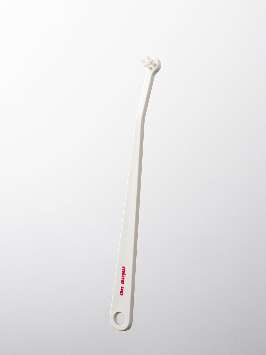 White cat toothbrush on a light gray background