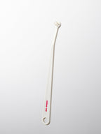 White cat toothbrush on a light gray background