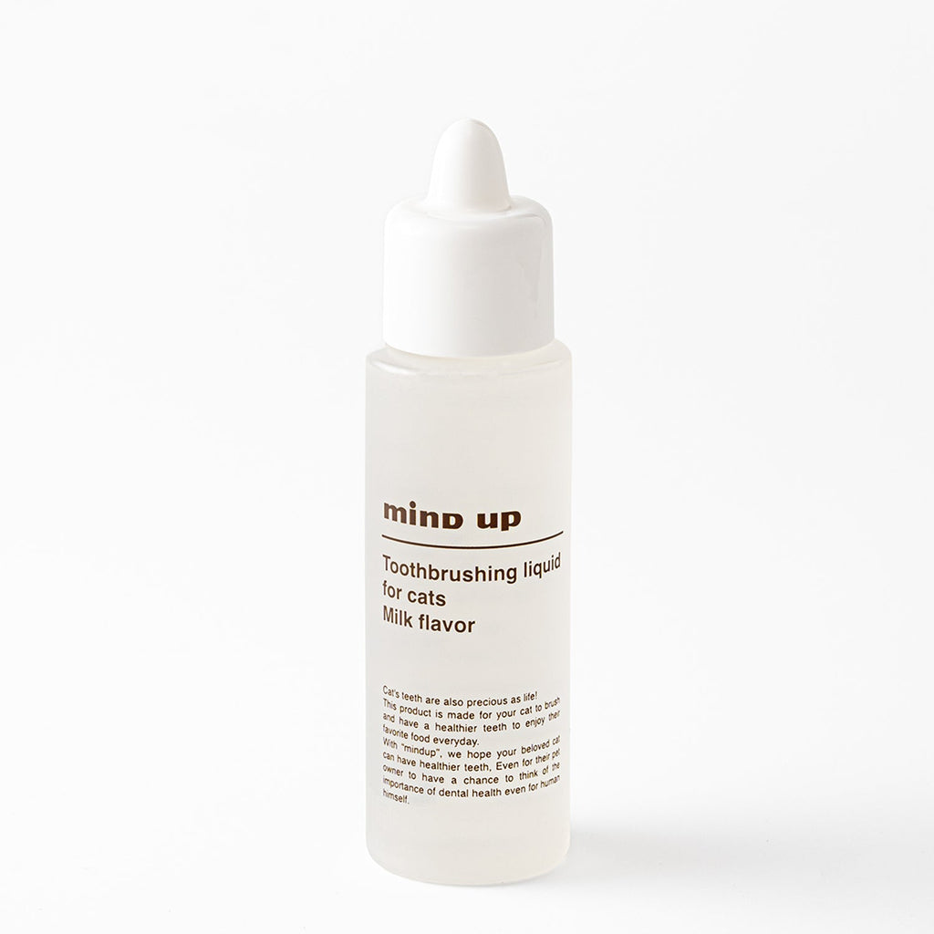 Bottle of 'mind up' toothbrushing liquid for cats on a white background