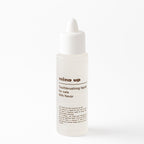 Bottle of 'mind up' toothbrushing liquid for cats on a white background