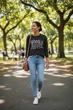 Woman walking in a park wearing a 'Dog Lover' shirt, blue jeans, and white sneakers.