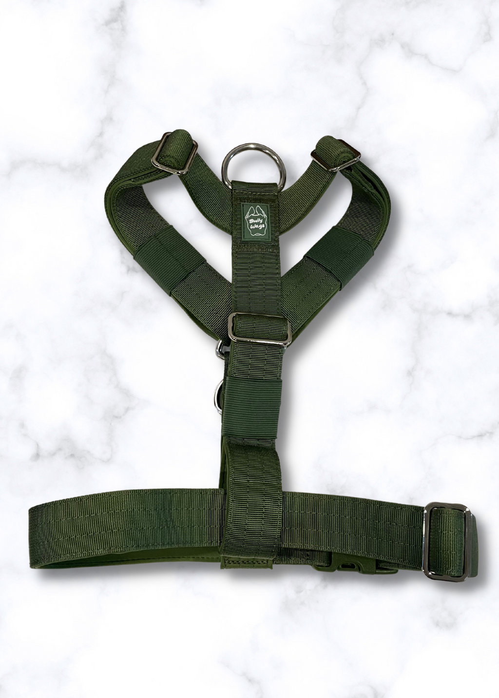 Green dog harness on a white marble background