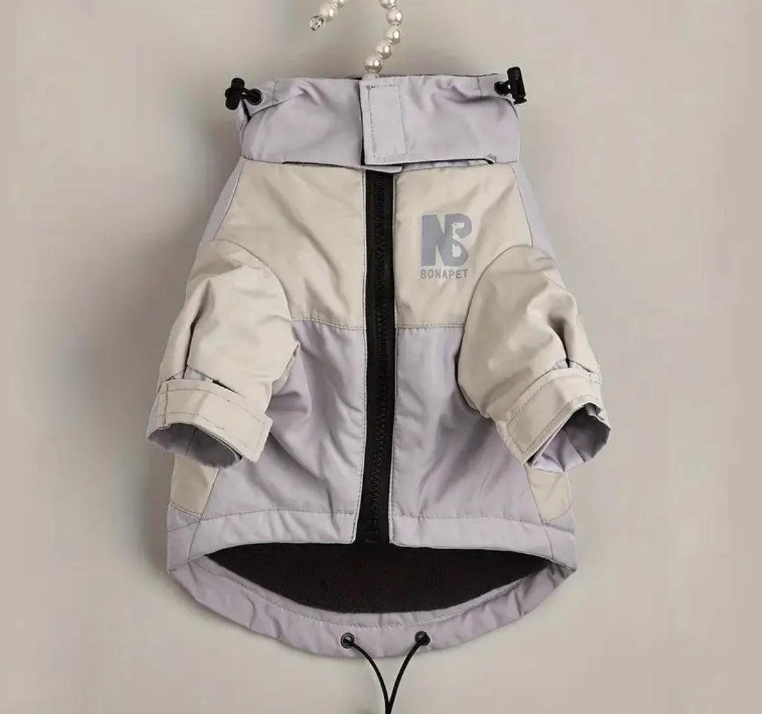 Dog jacket with a visible brand logo on a plain background