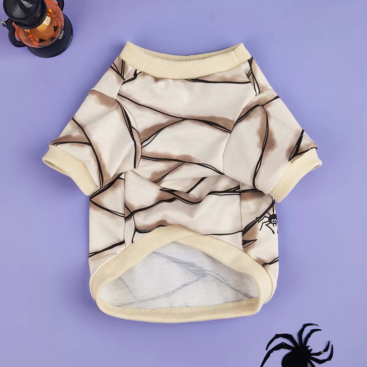 Dog shirt with spider web pattern on a purple background