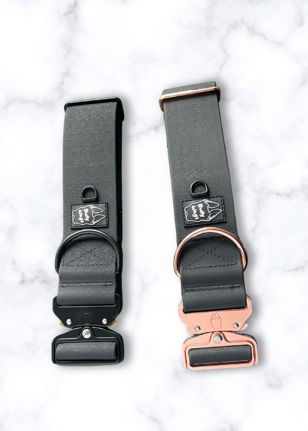 Two black dog collars with rose gold buckles on a white marble background
