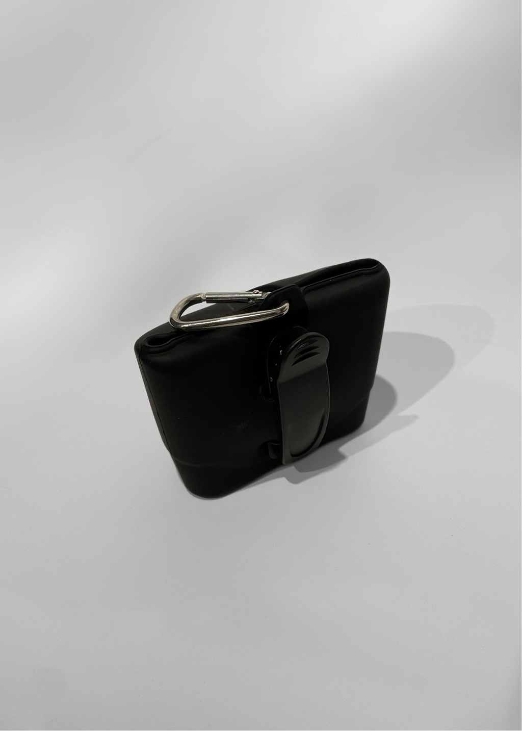 Black treat bag with a silver buckle on a white background