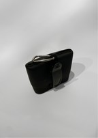 Black treat bag with a silver buckle on a white background