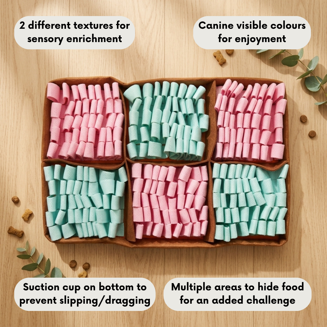 Snuffle mat with pink and green dog treats on a wooden surface