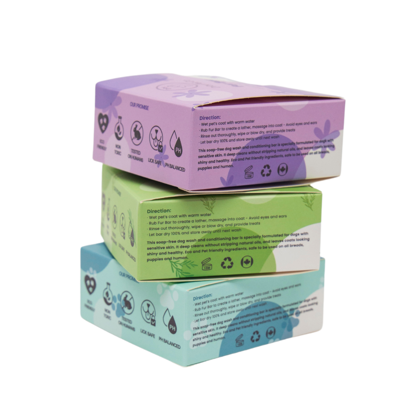 Stack of three boxes with purple, green, and blue lids on a white background