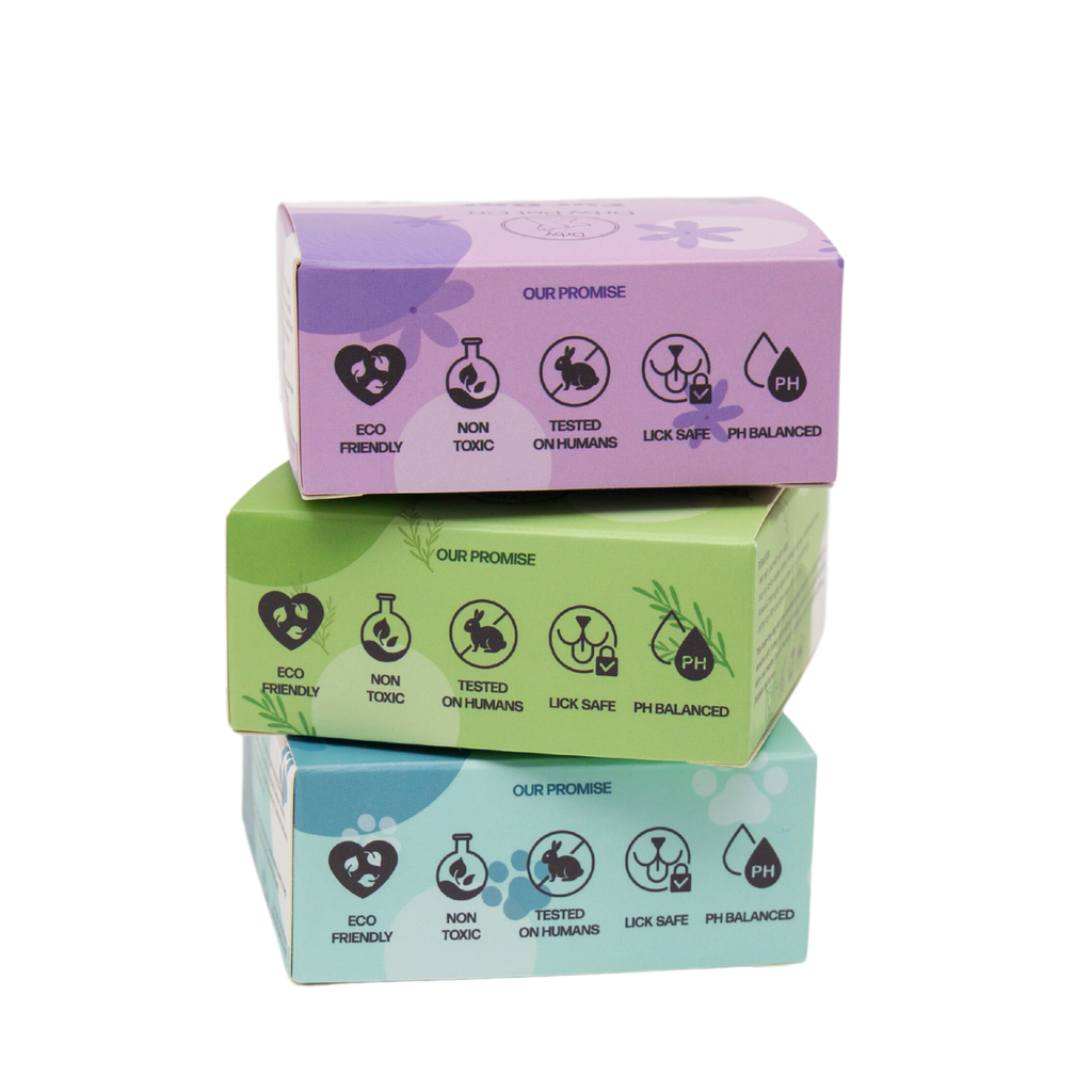 Three stacked boxes with purple, green, and blue lids on a white background