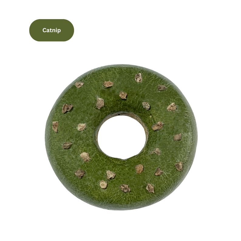 Green catnip donut toy on a white background