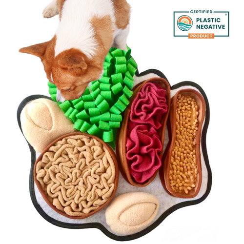 Dog toy shaped like a paw with various textures and a certified plastic-negative product label.