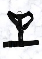 Black harness on a white marble background