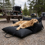 Dog lying on a black pet bed at a campground with text 'Unzip Front For Extra Lounging'.