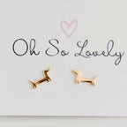Gold dog-shaped earrings on a 'Oh So Lovely' card.