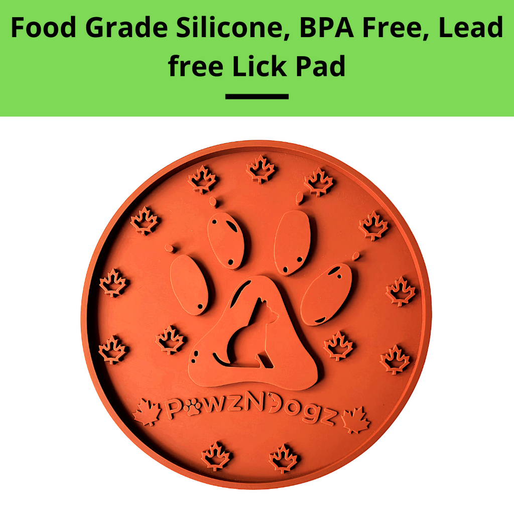 Orange paw-shaped lick pad with 'pawzNdogz' branding on a white background