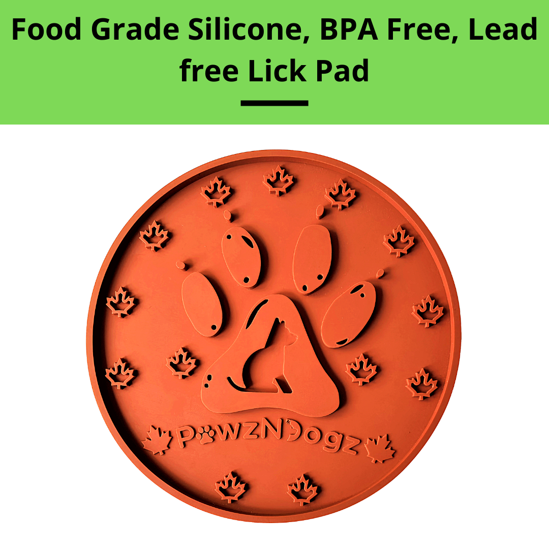 Orange paw-shaped lick pad with 'pawzNdogz' branding on a white background