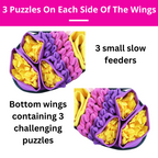 Purple and yellow puzzle toy with text indicating puzzles on each side of the wings and small feeders.