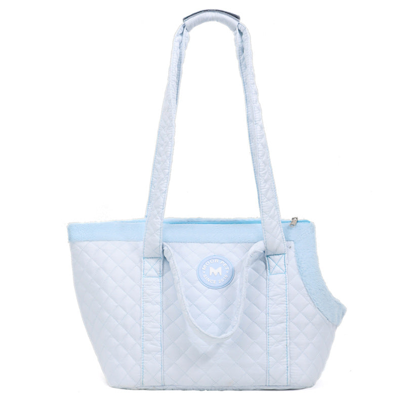 Light blue quilted pet carrier with a visible brand logo on a white background