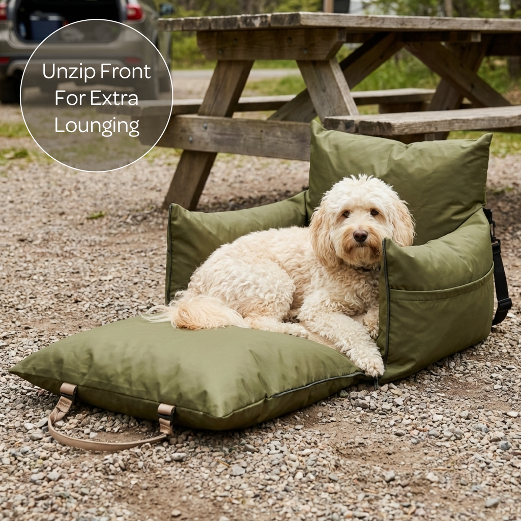 Dog lying on a green pet bed with a picnic table in the background