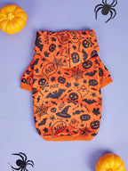 Orange Halloween-themed pet outfit with black graphics on a purple background