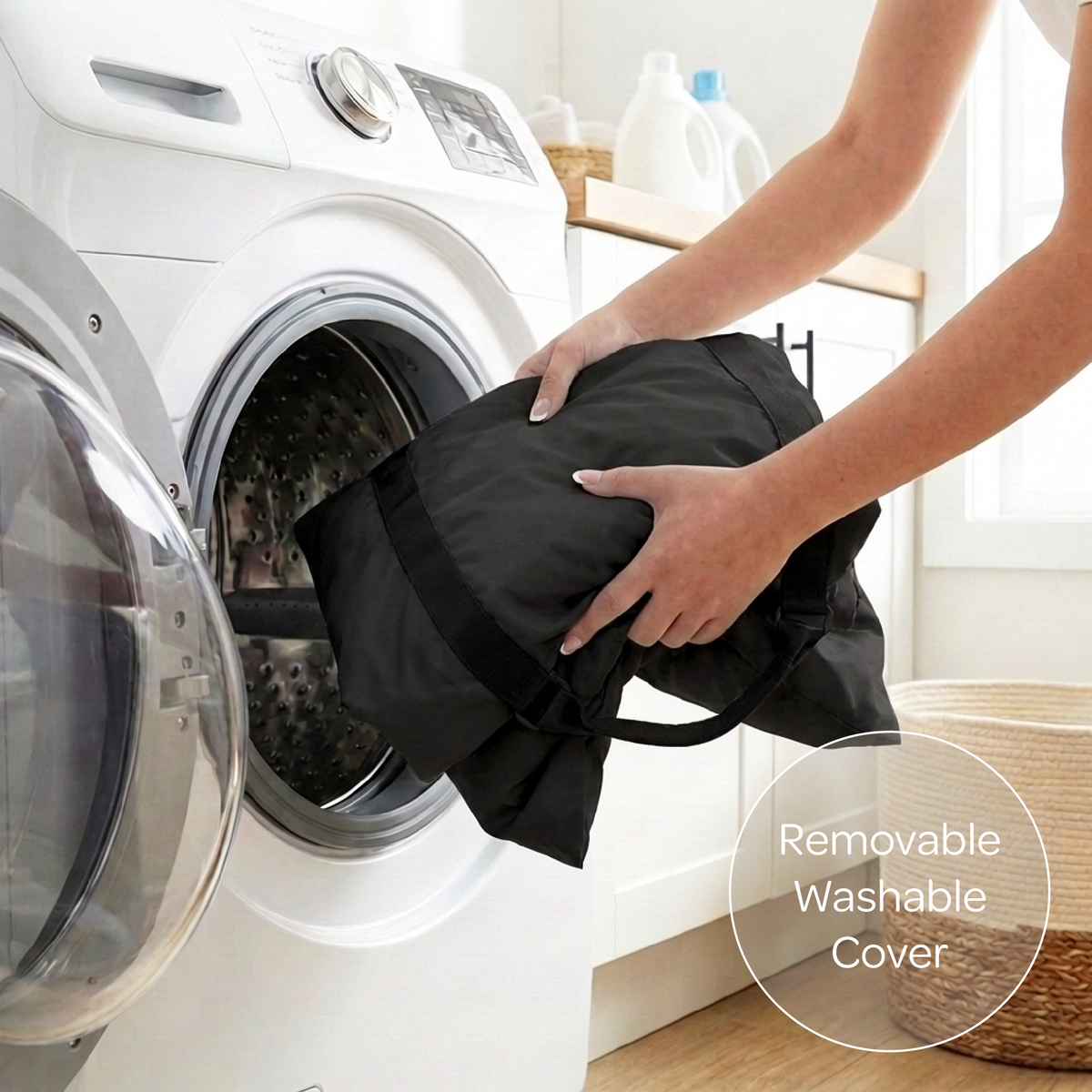Person placing a black pet seat cover into a washing machine with a focus on the removable washable cover feature.