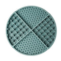 Round green silicone lick mat with textured surface on a white background
