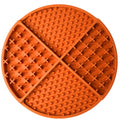 Orange silicone lick mat with textured surface on a white background
