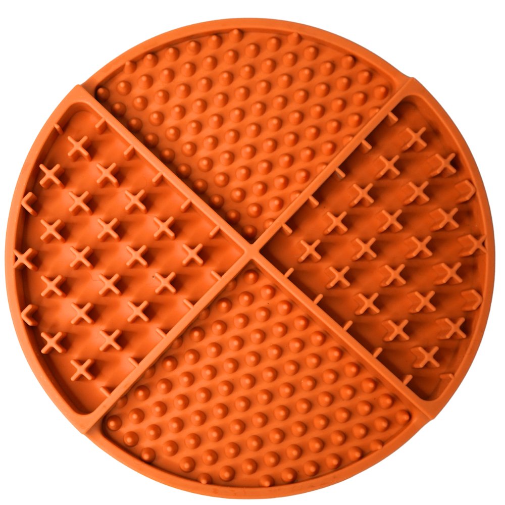 Orange silicone lick mat with textured surface on a white background