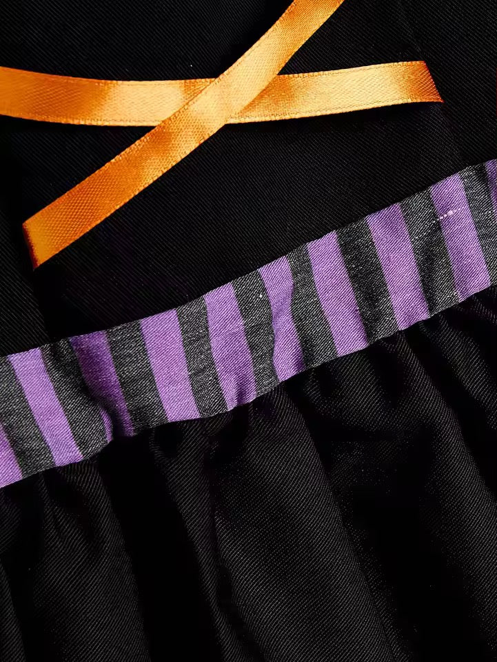 Black dress with orange ribbon and purple and gray striped trim