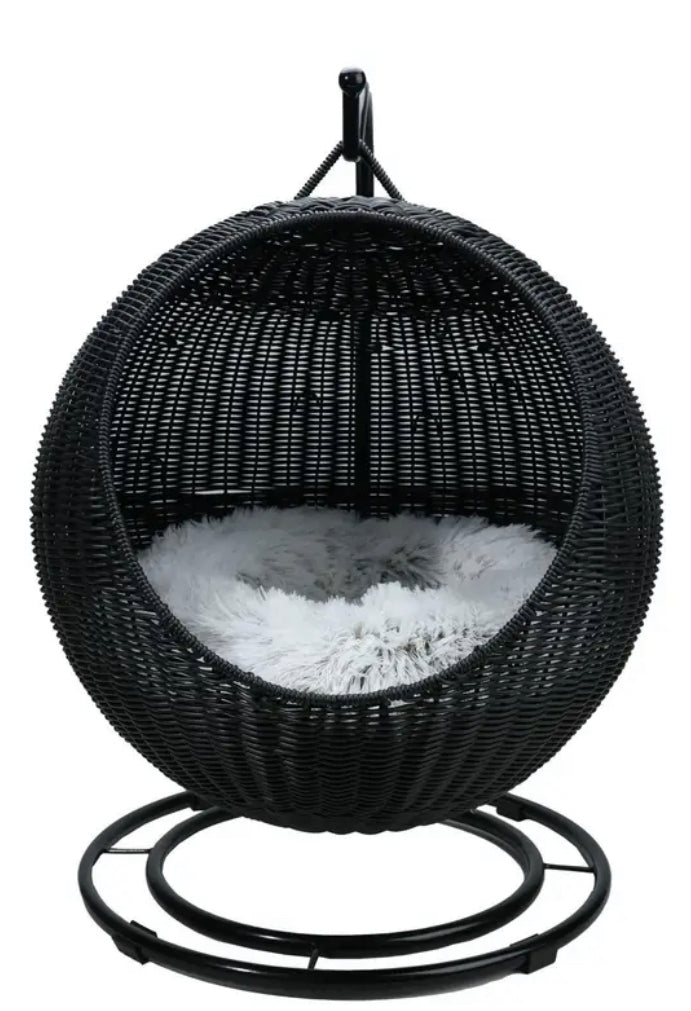 Black wicker hanging chair with white cushion on a white background