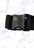 Black belt with a buckle on a white marble background