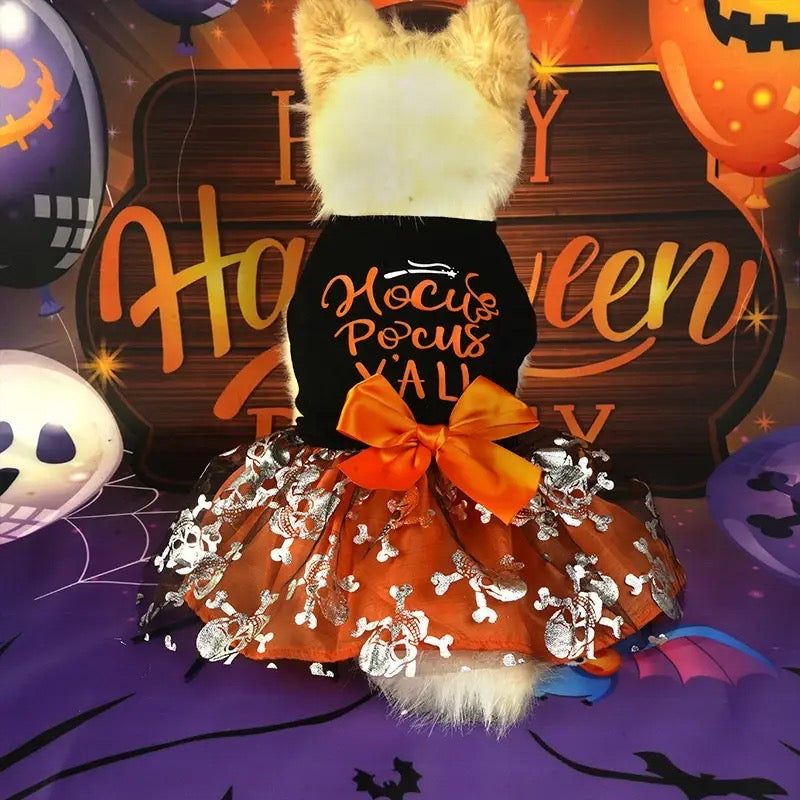 Halloween-themed outfit with 'Hocus Pocus' text and decorative elements on a festive background.