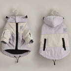 Two dog coats on hangers against a plain background