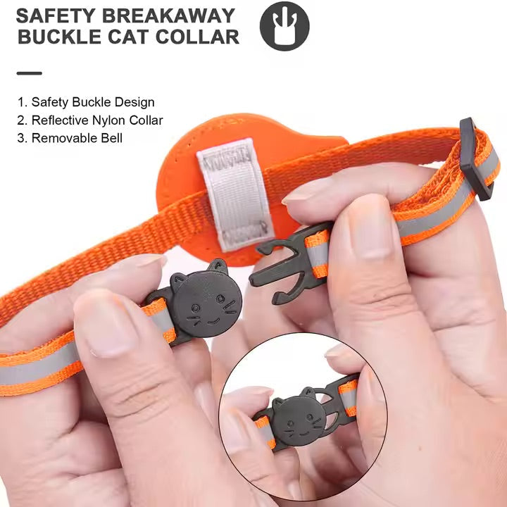 Orange cat collar with safety buckle, reflective material, and removable bell held by hands.