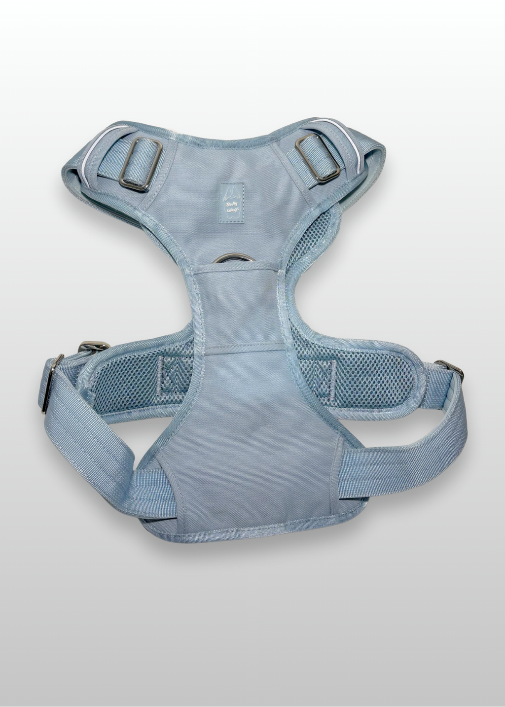 Blue dog harness on a light gray background