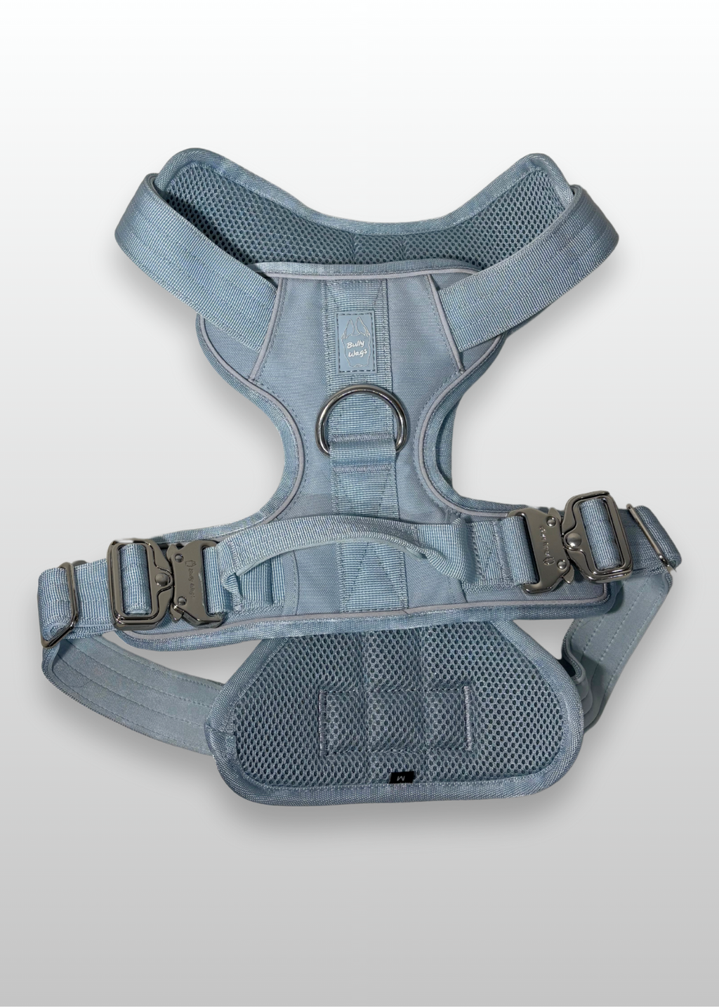 Blue dog harness on a light gray background